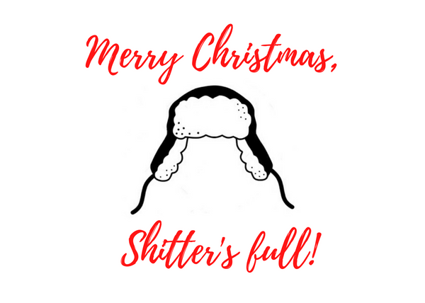 White seed paper greeting card says "Merry Christmas, Shitter's Full" with hat