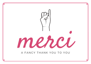 White seed paper greeting card saying "Merci, a fancy thank you to you" with sign language