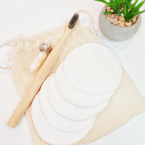 5 pack cotton terry reusable makeup remover pads with mesh laundering bag and plain bamboo toothbrush with compostable corn dental floss.