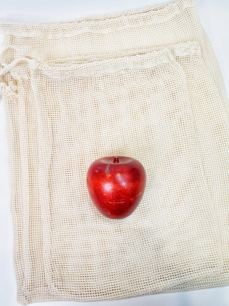 3 Pack Cotton mesh produce bags laid flat with apple for scale.