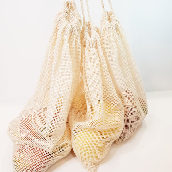 3 Pack Cotton mesh produce bags with fruit in them and drawstrings raised to hanging to show size.