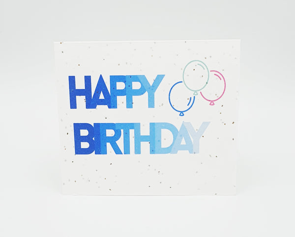 Plantable seed card with "Happy Birthday" in blue ombre colours and three balloons.