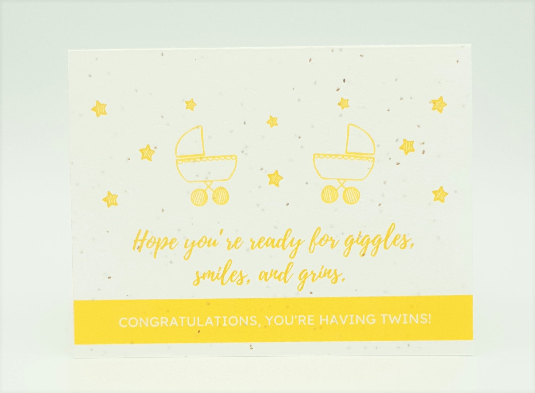 Plantable seed card with two yellow strollers and "Hope you're ready for giggles, smiles and grins.  Congratulations, you're having twins!"