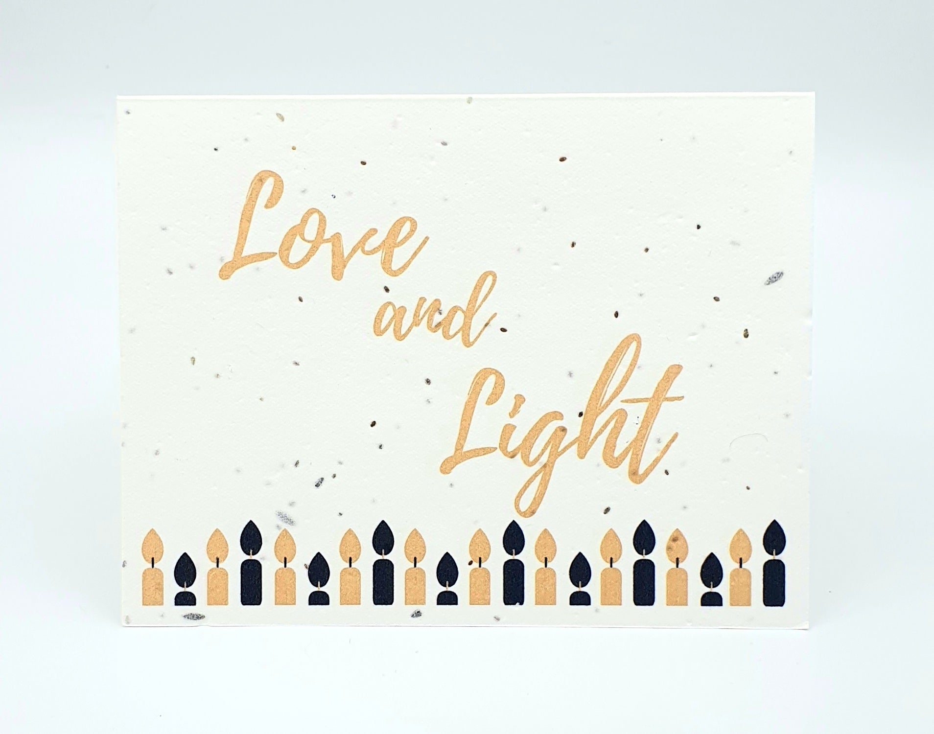 Plantable seed paper card with Love and Light and black and gold candles.