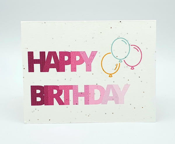 Plantable seed card with "Happy Birthday" in pink ombre colours and three balloons.