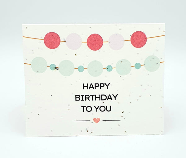 Plantable seed card with "Happy Birthday to you" and round banners.