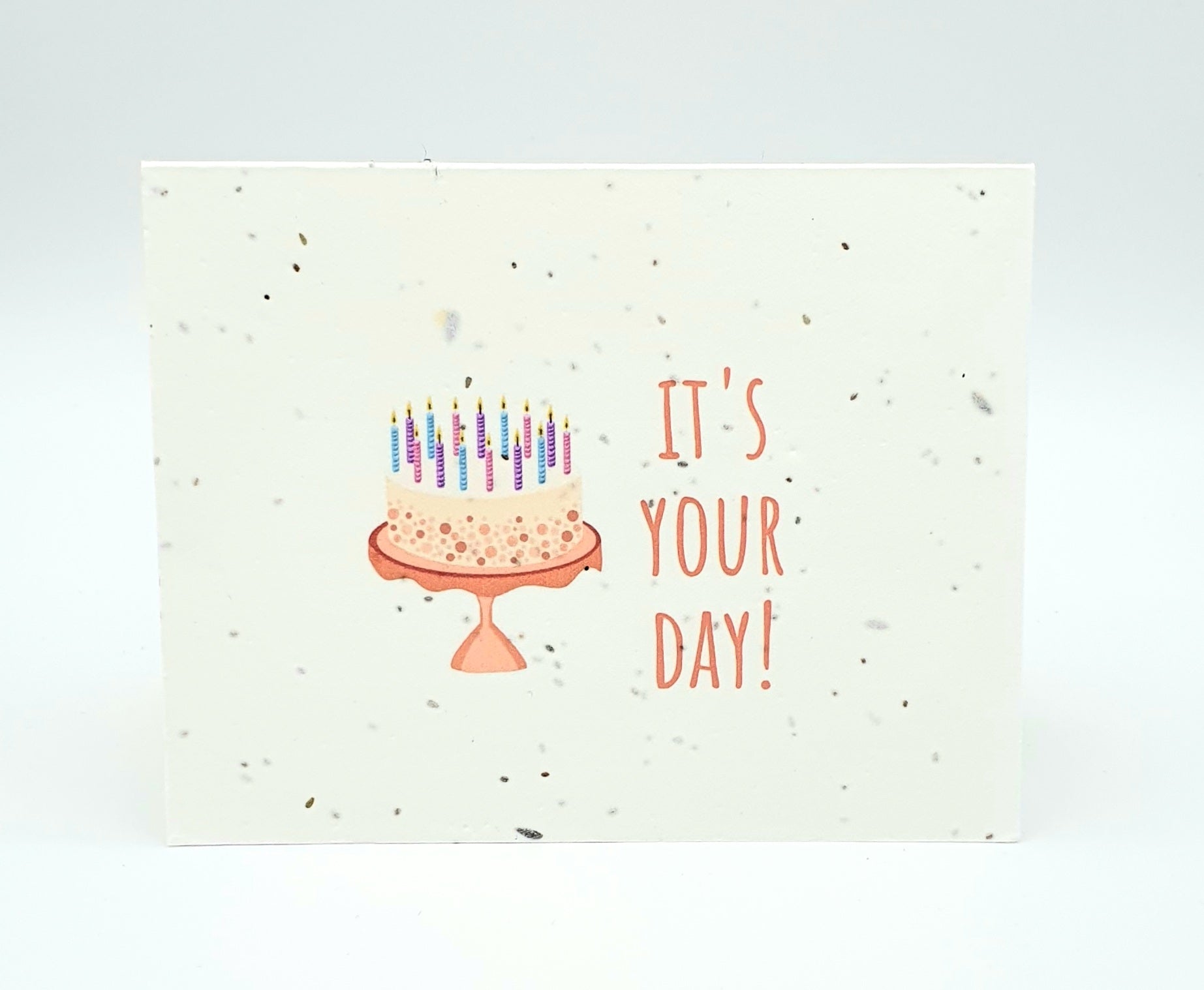 Plantable seed card with peach coloured cake and candles "It's your day!"