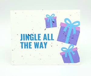 Plantable seed paper card with Jingle All the Way and blue and purple presents.