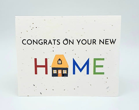 Plantable seed card with "Congrats on your new Home" - last word with different coloured letters and the O is an image of a house.