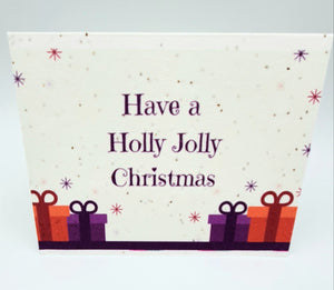 Plantable seed paper card Have a Holly Jolly Christmas with red and purple gifts and snowflakes.