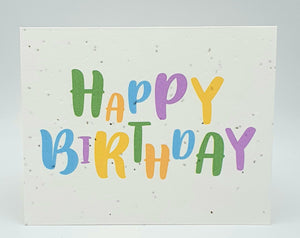 Plantable seed card with "Happy Birthday" written in alternating colours.
