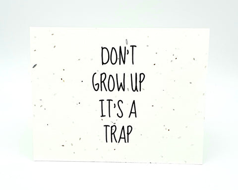 Plantable seed card with "Don't Grow Up It's A Trap"