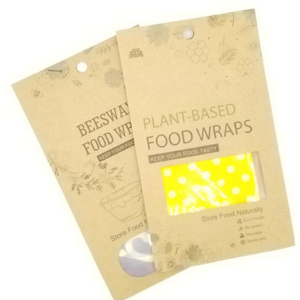 Two packages - beeswax food wraps in blue designs and plant-based food wraps in yellow designs.