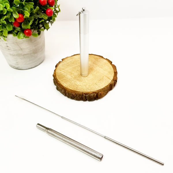 Silver reusable stainless steel telescopic straw collapsed with extended telescopic straw brush and silver carrying case.
