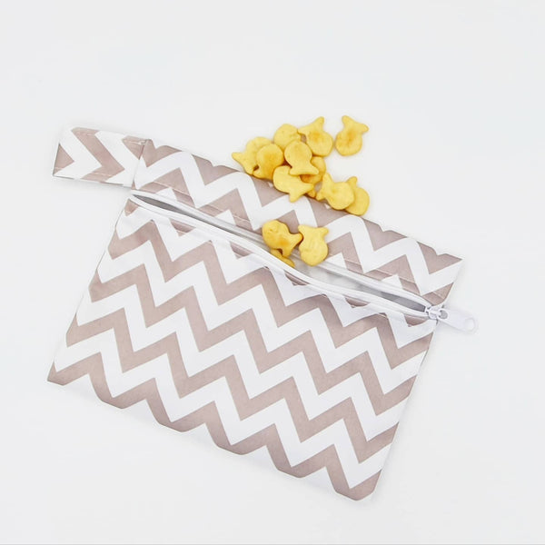 Small reusable waterproof bag with grey chevron bag and crackers coming out of it.