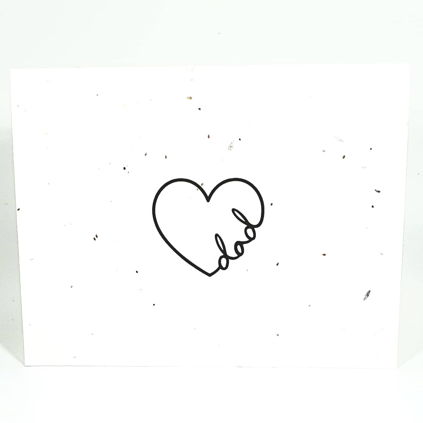 Plantable seed card heart with the word dad written in cursive in the line of the heart drawing.